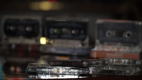 Several audio tapes against a background of moving graphics Stock Footage 250290253