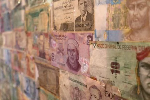 Several banknotes glued on a wal Stock Photos