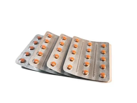 Several blisters with beige tablets in three rows isolated on a white backgro Stock Photos