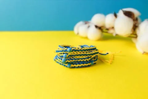 Several blue yellow macrame bracelets with beads. Wristbands in Ukraine Stock Photos