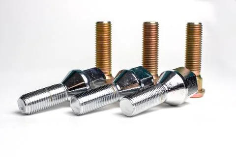Several bolts and studs for installing the wheel on the car Stock Photos