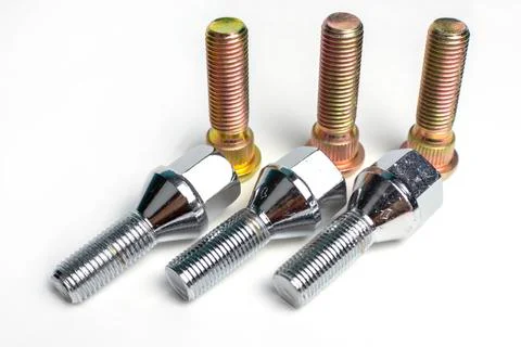 Several bolts and studs for installing the wheel on the car Stock Photos