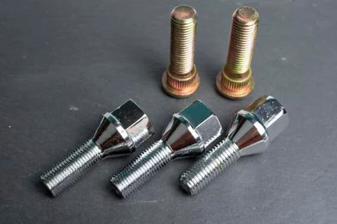 Several bolts and studs for installing the wheel on the car Stock Photos