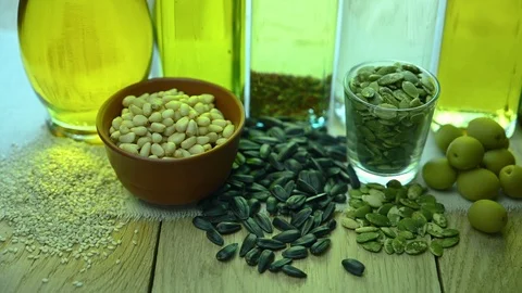 Several bottles of different oil stand on a wooden table Stock Footage 122097453