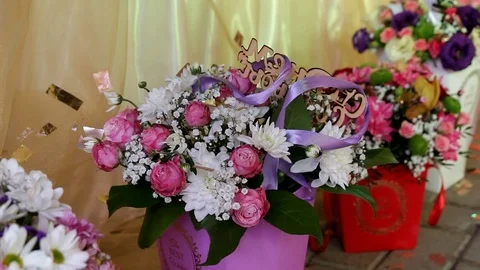 Several bouquets in boxes stand in front of the table Video stock 104519090