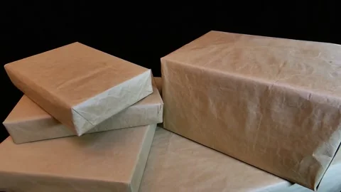 Several boxes of different sizes are wrapped in plain paper. Stock Footage 141020179