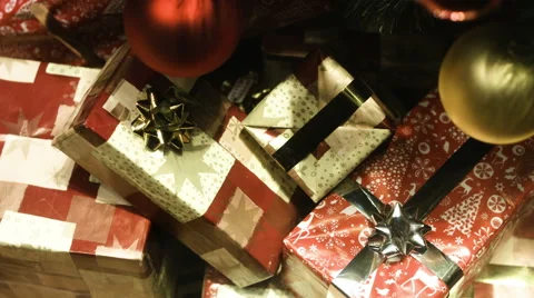Several boxes of gifts wrapped in paper and decorated with ribbons. Top view Stock Footage 64890048