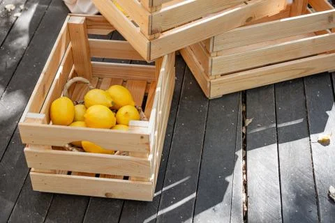 Several boxes on a wooden deck with some lemons. Stock Photos