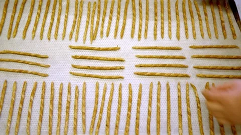 Several Breadsticks on a Large Baking Sheet Ready for Baking Stock Footage 315219845