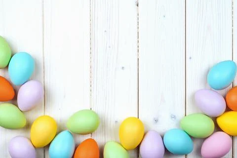 Several bright color dyed easter eggs on wooden background Stock Photos
