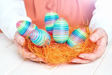 Several bright color handmade easter eggs in hands Stock Photos