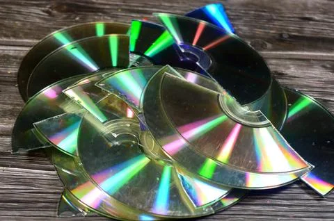 Several broken compact discs CDs that display a rainbow-like effect known a.. Stock Photos