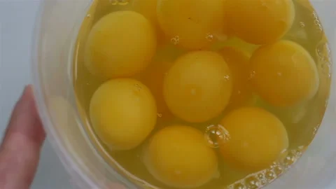 Several broken eggs close-up. The hand rotates the container. Real time, contain Stock Footage 142241606