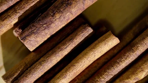 Several brown cinnamon sticks rotating slowly on the table Stock Footage 333809953