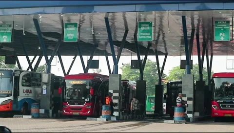 Several buses lined up parked at purabaya or bungurasih terminal. Stock Footage 303570967