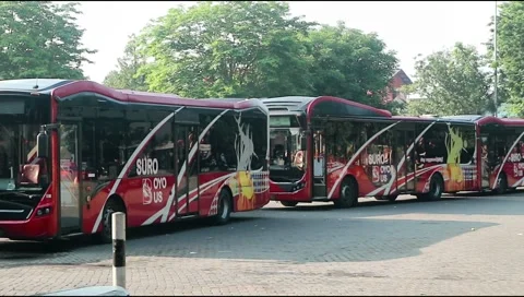 Several buses lined up parked at purabaya or bungurasih terminal. Stock Footage 303571283