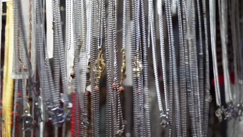 Several chains with locket hanging in a store for sale Stock Footage 316239290