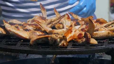 Several chefs prepare chicken wings at the stake Stock-Footage 85384348