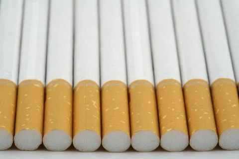 Several cigarettes stacked on table Stock Photos