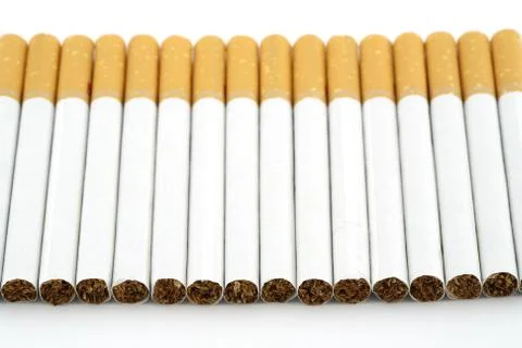 Several cigarettes stacked on table Stock Photos