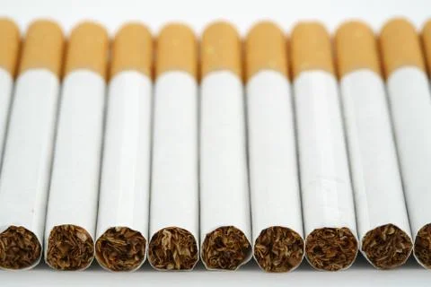 Several cigarettes stacked on table Stock Photos
