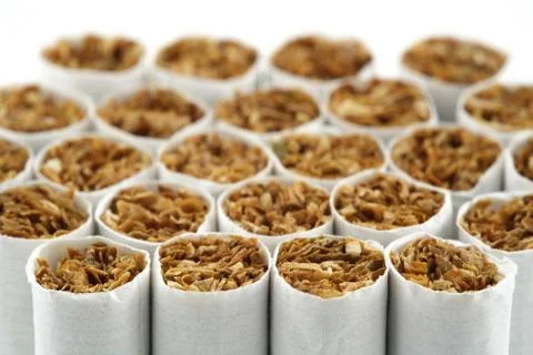 Several cigarettes stacked on table Stock Photos