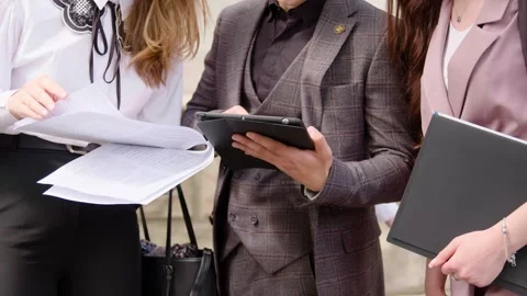 Several classically dressed entrepreneurs discussing and planning several Stock Footage 246080250