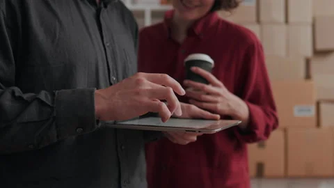 Several colleagues are standing in front of a warehouse of boxes of packages Stock Footage 230699627