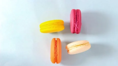 Several colored macarons move around on a blue background. Stock Footage 161104648