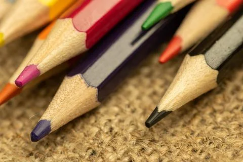 Several colored pencils of different colors on a background of coarse burlap Stock Photos