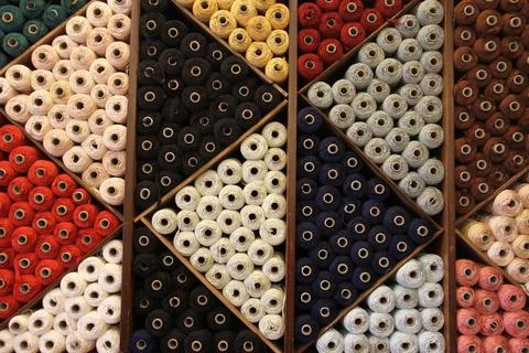 Several colored spools grouped in store Stock Photos