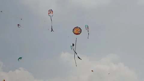 Several colorful handmade kites flying in the sky at Sumpango kite festival Vídeos de archivo 320984595