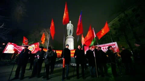 Several communists stand with flag in front of monument at approved meeting Stock Footage 10680685