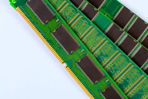 Several computer memory sticks lie on white surface green circuits dark chips Stock Photos