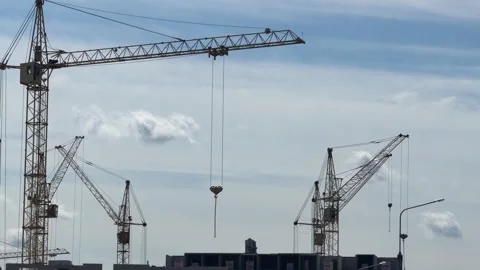 Several construction cranes operating at a building site of a modern house Vídeos de archivo 337627909