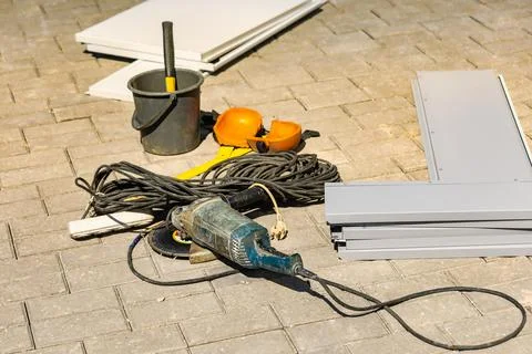 Several construction tools and materials are on the ground at a building si.. Stock Photos