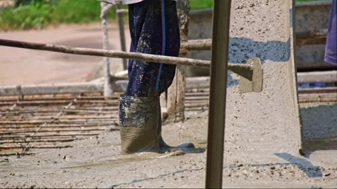 Several construction workers are using shovels to spread ready-mixed concre.. Stock Footage 300072507