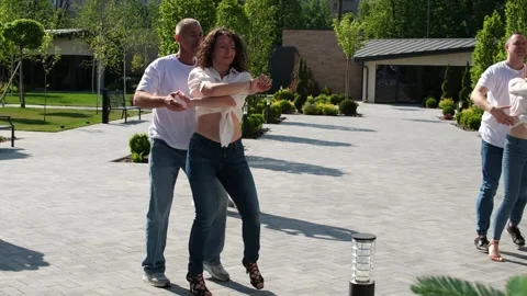Several couples in jeans and T-shirts dance in nature Guy and girl dance Stock Footage 276909821