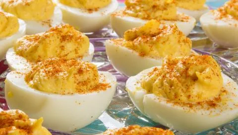 Several Deviled Eggs topped with paprika Stock Photos