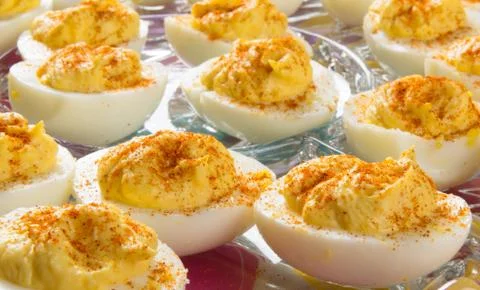 Several Deviled Eggs topped with paprika Stock Photos