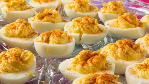 Several Deviled Eggs topped with paprika Stock Photos
