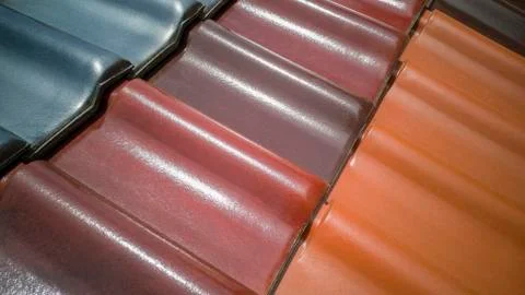 Several diagonal rows of multicolored clay roof tiles for sale in German store Stock Photos