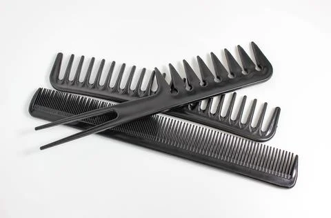 Several different black combs on a white background. Stock Photos