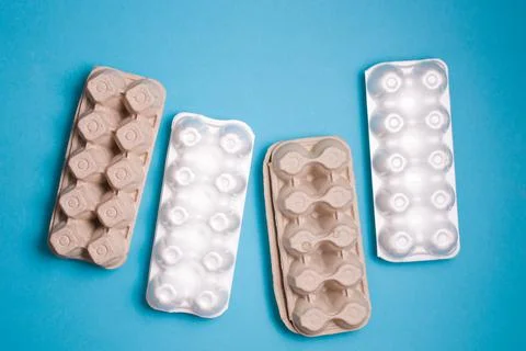 Several different boxes for eggs on a blue background, copy space, top view,  Stock Photos