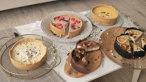 Several different cheesecakes on the table. Camera movement Stock Footage 129023313