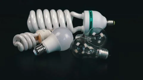 Several different light bulbs on the black table Stock Footage 105745257