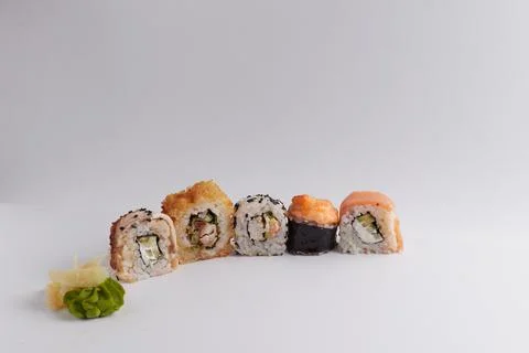 Several different rolls on the table, Asian food, side view, light background Stock Photos
