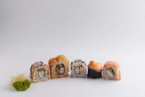 Several different rolls on the table, Asian food, side view, light background Stock Photos