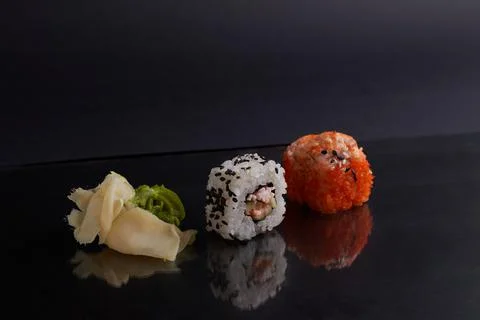 Several different rolls on the table, asian food, side view, dark background Stock Photos