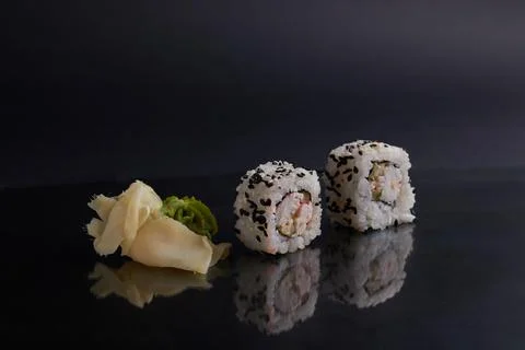 Several different rolls on the table, asian food, side view, dark background Stock Photos